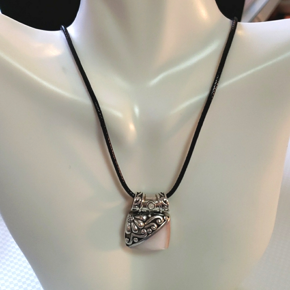 Unique silver tone and pink pearlesque pendant on black cord